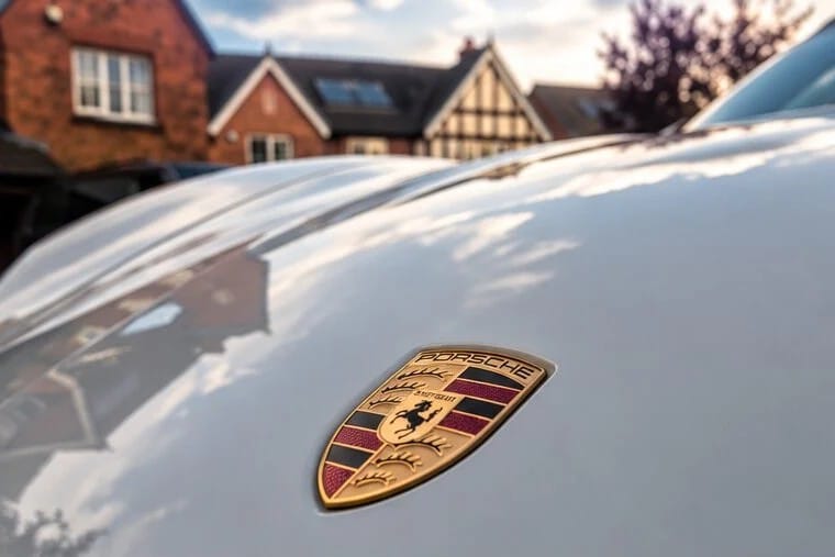 Porsche bonnet badge on glossy white paint